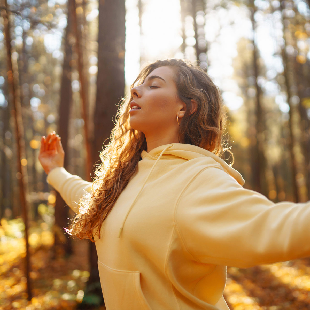 PEA Kapseln von Waldkraft: Junge Frau meditiert im Wald