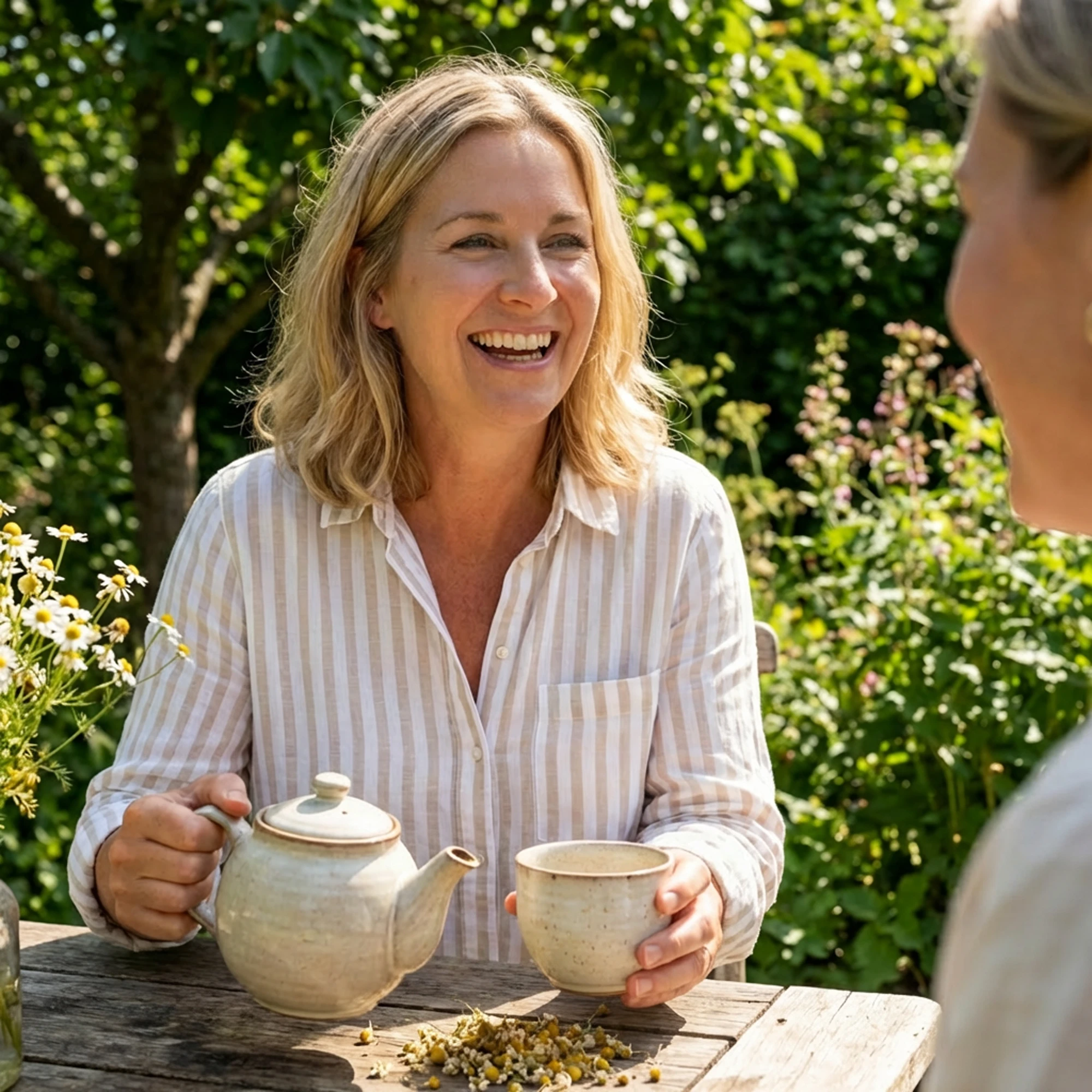 Monte Nativo Kamillenblüten - Frau mit Teetasse lächelt in der Sonne